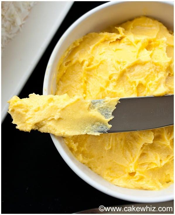 A close-up shot of the smooth, luscious Mango Frosting, ready to be piped onto your baked treats.