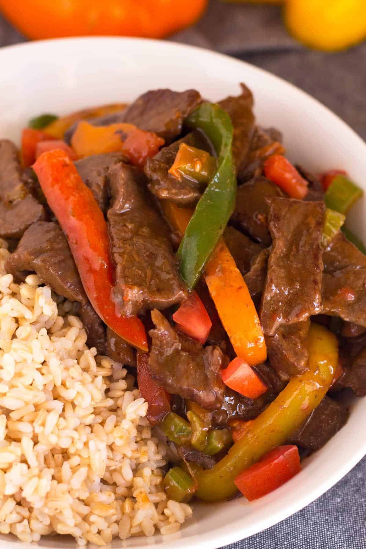  A sizzling skillet of Mexican Pepper Steak with a side of fluffy brown rice