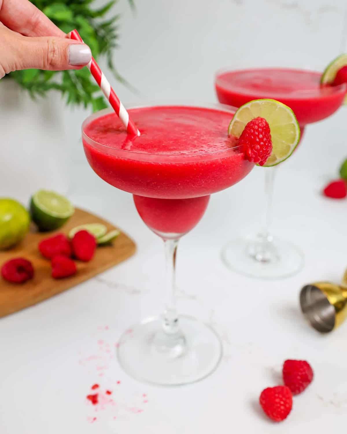 Garnished with a slice of lime and a fresh raspberry for a pop of color.